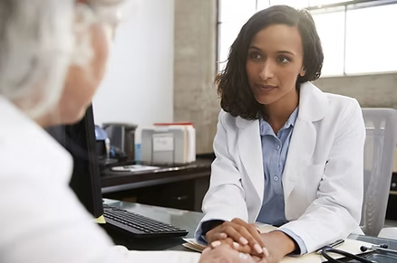 A doctor attentively listens and provides guidance during a patient consultation.